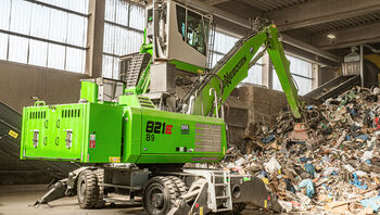 waste sorting facility: electric excavator material handler handling machine SENNEBOGEN 821 E with diesel generator power pack and ceiling power supply
