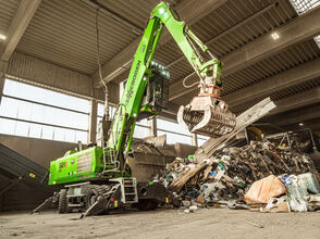ELECTRIC MATERIAL HANDLER SENNEBOGEN 821 WITH CEILING POWER SUPPLY A IN WASTE SORTING FACILITY, processing of recyclable materials