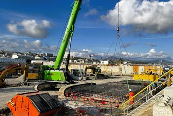 SENNEBOGEN 6113 E telescopic crawler crane positions a reinforcement cage on a deep foundation construction site in Nice.