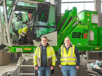 ELECTRIC MATERIAL HANDLER SENNEBOGEN 821 WITH CEILING POWER SUPPLY A IN WASTE SORTING FACILITY, processing of recyclable materials