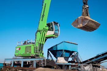 SENNEBOGEN 830 G Hybrid loads sand into a hopper during bulk material handling at the Port of Amsterdam.