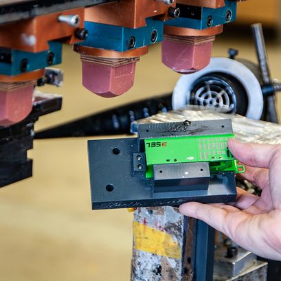 Employee applying pad printing to a Conrad model component.