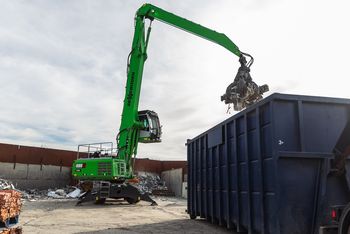 SENNEBOGEN 835 G Hybrid loading non-ferrous scrap into a container with a grab at a recycling yard.