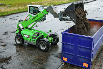 SENNEBOGEN telehandler 355 E loading of compost in container composting plant elevating cab shovel