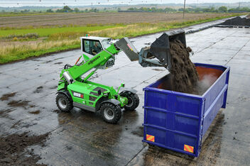 SENNEBOGEN telehandler 355 E loading of compost in container composting plant elevating cab shovel