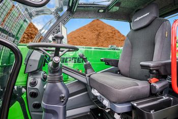 Comfort seat inside the operator's cab of the SENNEBOGEN 360 G telehandler for ergonomic operation.