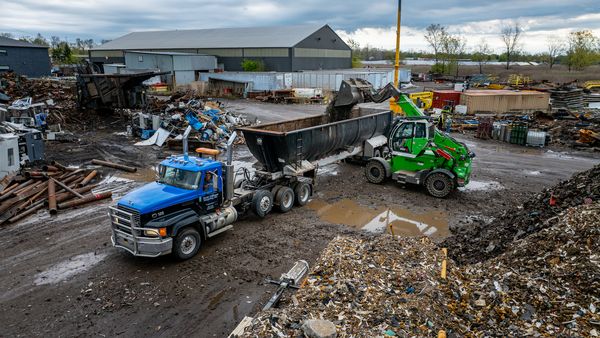 A SENNEBOGEN 360G at Twin Village Recycling, loading a truck trailer with processed recycled material.