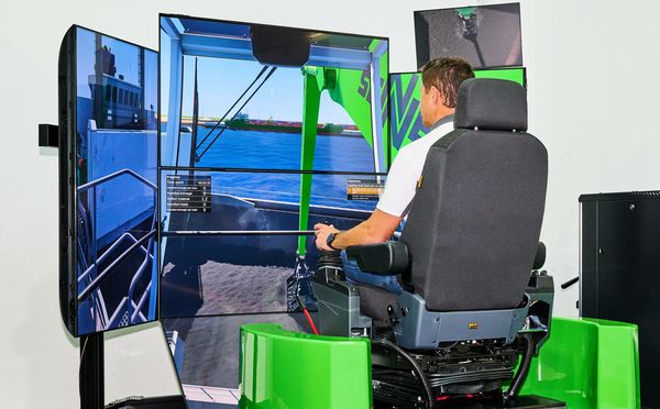 Visitors use the SENNEBOGEN log-handling simulator to control virtual log handling on multiple screens.