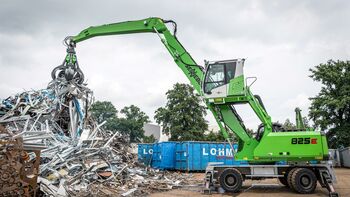 Loading scrap, scrap handling with material handler scrap loader SENNEBOGEN 825 E with orange peel grab on the scrap yard