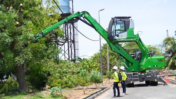 SENNEBOGEN 718 E performing safe tree care operations near overhead power lines.