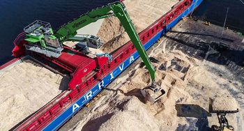 A SENNEBOGEN 875 E on a mobile crossbeam during bulk material handling.