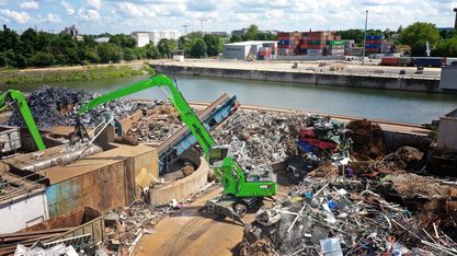 Scrap handler material handler machine SENNEBOGEN 835 G Hybrid scrap handling on scrap yard with orange peel grab