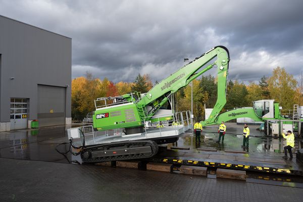 The SENNEBOGEN 824 G Electro is being loaded onto a low-loader for heavy transport.