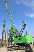 SENNEBOGEN 1100 E crawler crane to dismantle a sheet pile wall to create more space for housing