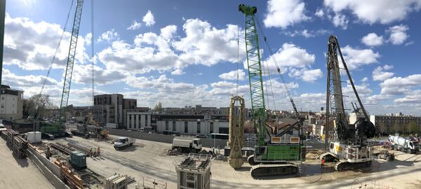SENNEBOGEN 6140 HD rope excavator and 7700 R-SL crawler crane used in building construction / civil engineering for Grand Paris Express in France