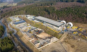 ELECTRIC MATERIAL HANDLER SENNEBOGEN 821 WITH CEILING POWER SUPPLY A IN WASTE SORTING FACILITY, processing of recyclable materials