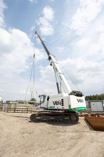 SENNEBOGEN 653 Electro Battery crane positioning a precast concrete element during the construction of an electric bus depot in Breda.