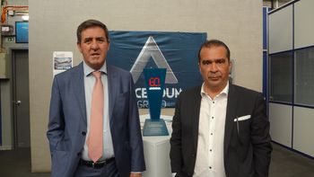Two representatives standing in front of the Ascendum company logo.